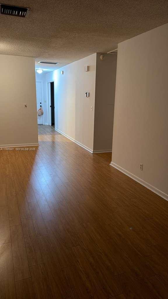 13731 Flora Place, Unit A Delray Beach, FL 33484 - Photo 14 of 21 a view of a hallway with wooden floor