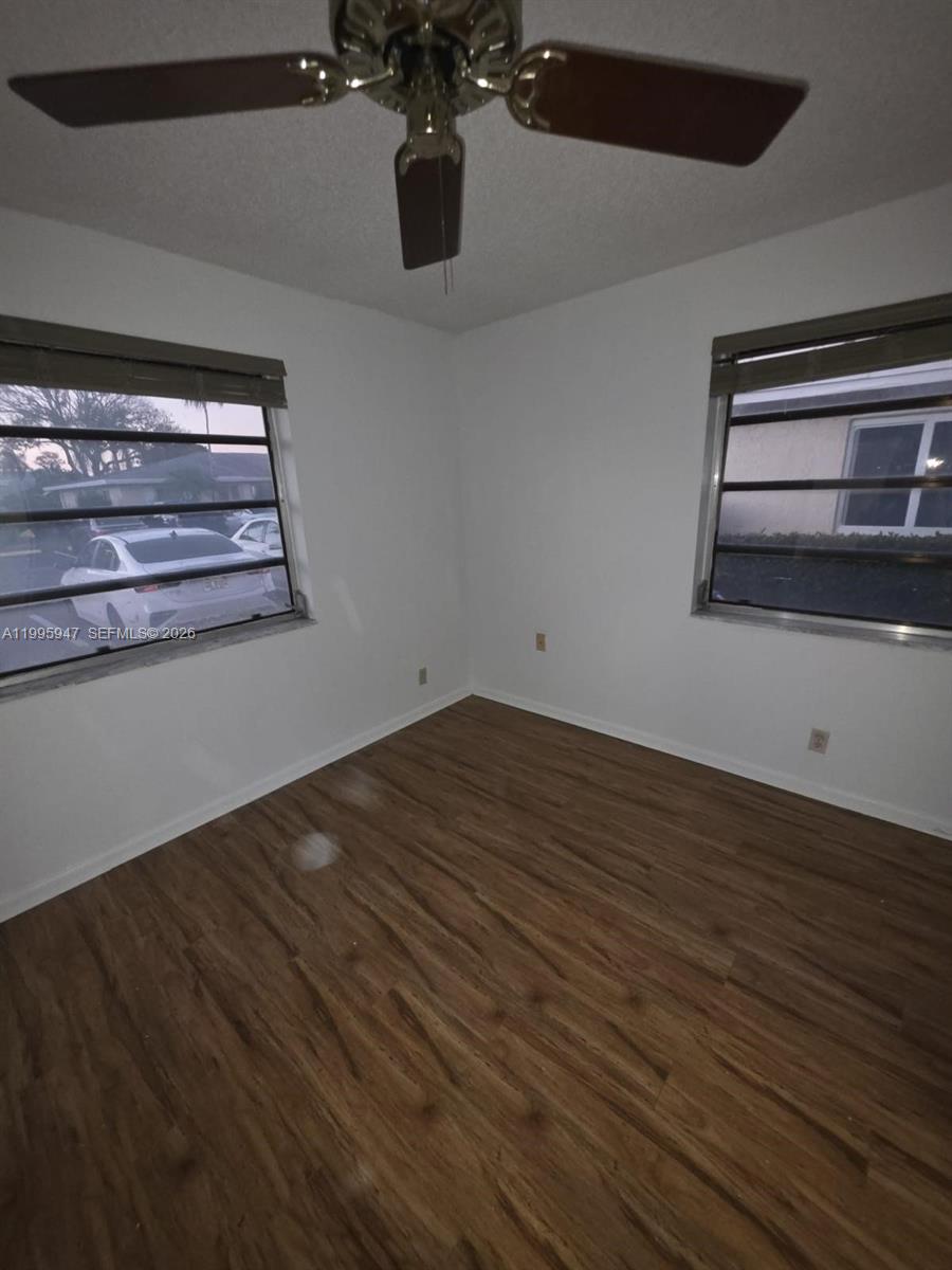 13731 Flora Place, Unit A Delray Beach, FL 33484 - Photo 2 of 21 a view of water heater room with wooden floor