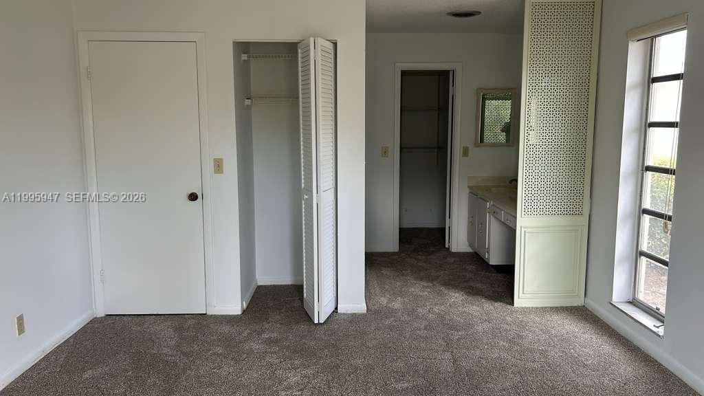 13731 Flora Place, Unit A Delray Beach, FL 33484 - Photo 3 of 21 an empty room with windows and closet