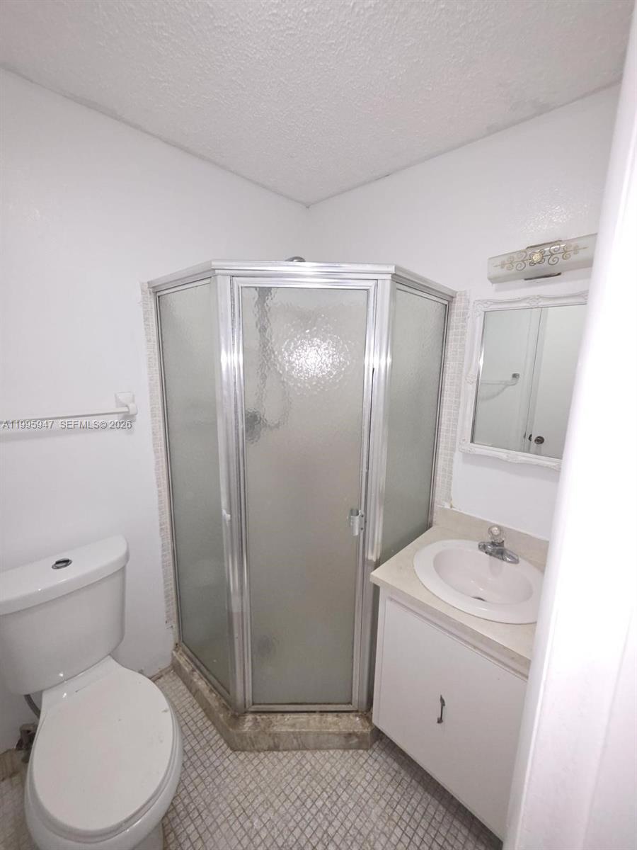 13731 Flora Place, Unit A Delray Beach, FL 33484 - Photo 6 of 21 a bathroom with a sink a toilet and shower