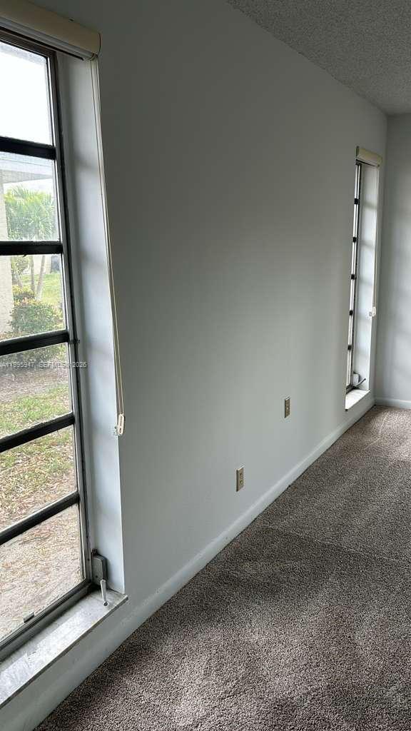 13731 Flora Place, Unit A Delray Beach, FL 33484 - Photo 8 of 21 an empty room with windows