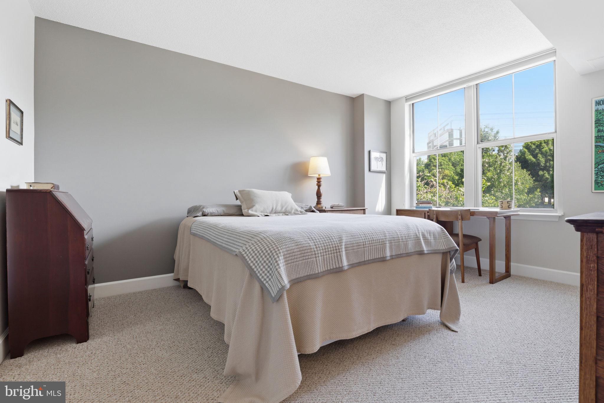 11800 Sunset Hills Road, Unit 218 Reston, VA 20190 - Photo 20 of 38 a bedroom with a bed lamp and window