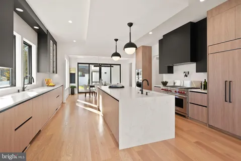 a view of a a dining room with furniture window and wooden floor