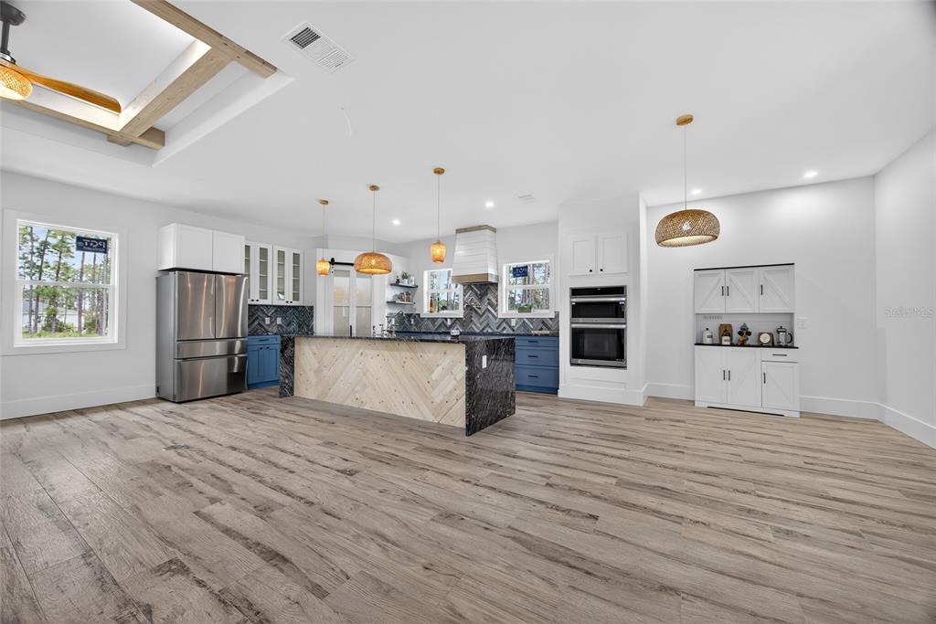 14192 Riseley Avenue Port Charlotte, FL 33953 - Photo 12 of 54 a large kitchen with cabinets and wooden floor