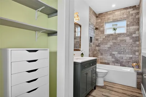 a kitchen with stainless steel appliances granite countertop a sink and a stove top oven with wooden floor