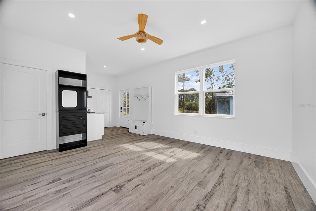 14192 Riseley Avenue Port Charlotte, FL 33953 - Photo 28 of 54 a view of an empty room with a window and wooden floor