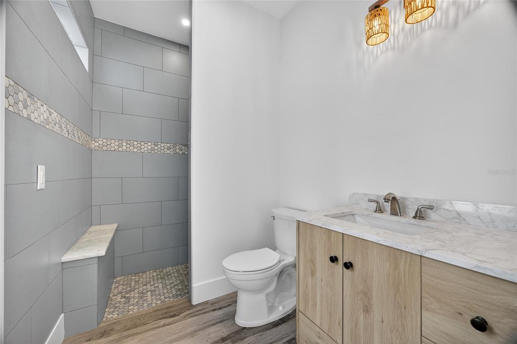 14192 Riseley Avenue Port Charlotte, FL 33953 - Photo 32 of 54 a bathroom with a granite countertop toilet a sink and a mirror