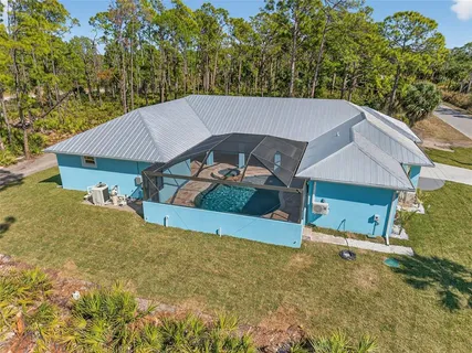 an aerial view of a house with a yard