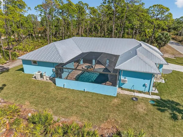 an aerial view of a house with a yard