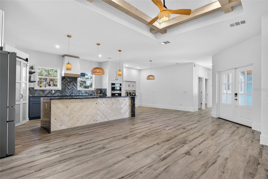 14192 Riseley Avenue Port Charlotte, FL 33953 - Photo 7 of 54 a large kitchen with stainless steel appliances granite countertop a large counter top and wooden floors