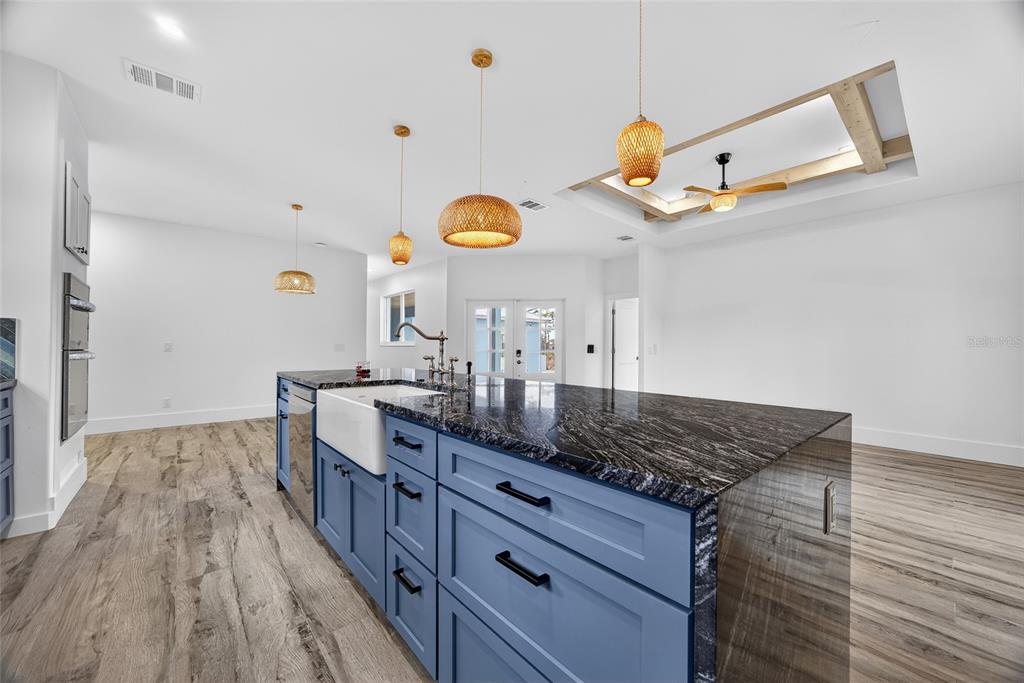 14192 Riseley Avenue Port Charlotte, FL 33953 - Photo 10 of 54 a kitchen with a wooden floor and a view of living room