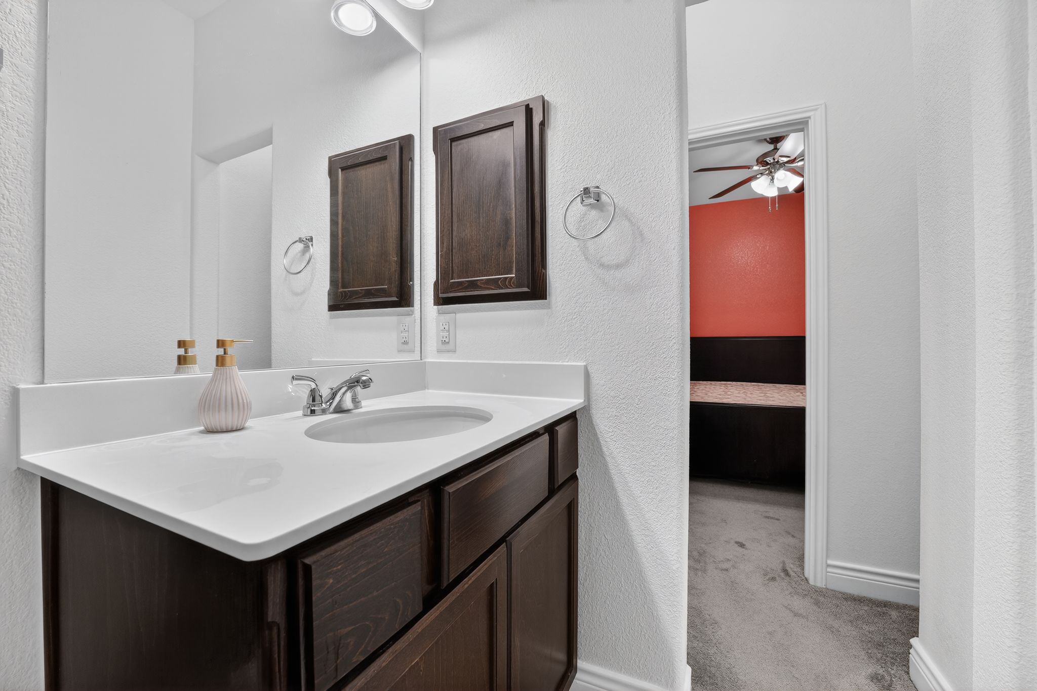 400 Cortona Lane Georgetown, TX 78628 - Photo 29 of 40 Bathroom with a textured wall, vanity, light colored carpet, and ceiling fan