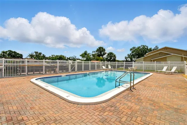 a view of a house with swimming pool and sitting area