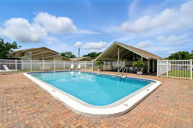 a view of a swimming pool with a patio