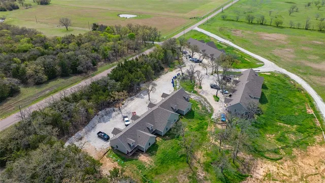 an aerial view of a house with outdoor space and street view