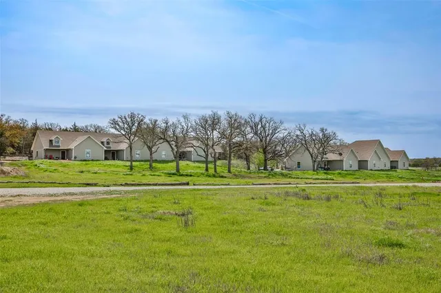 a view of a golf course with a building in the background