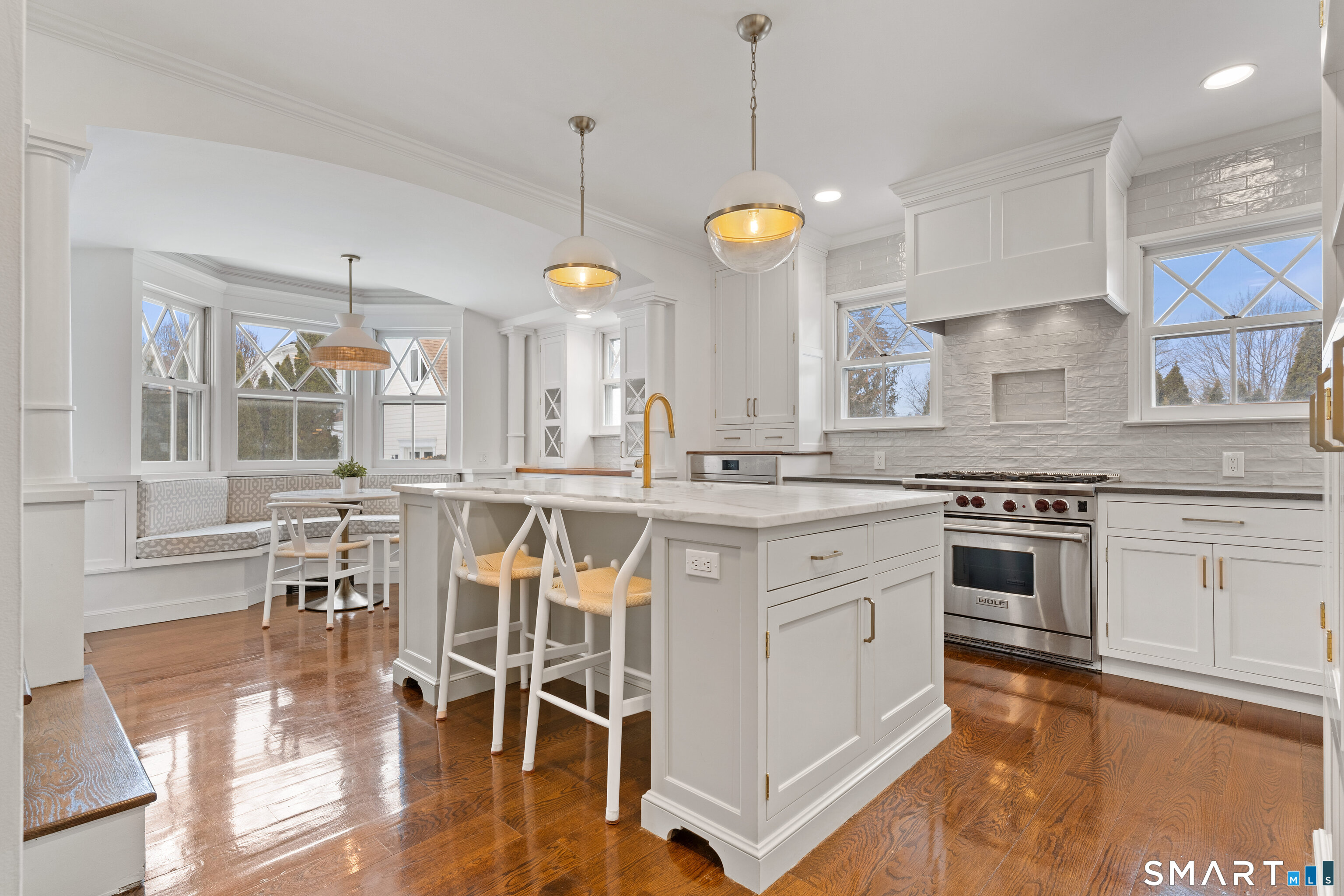 40 Rogers Road Stamford, CT 06902 - Photo 11 of 40 a kitchen with stainless steel appliances granite countertop a stove and white cabinets with wooden floor
