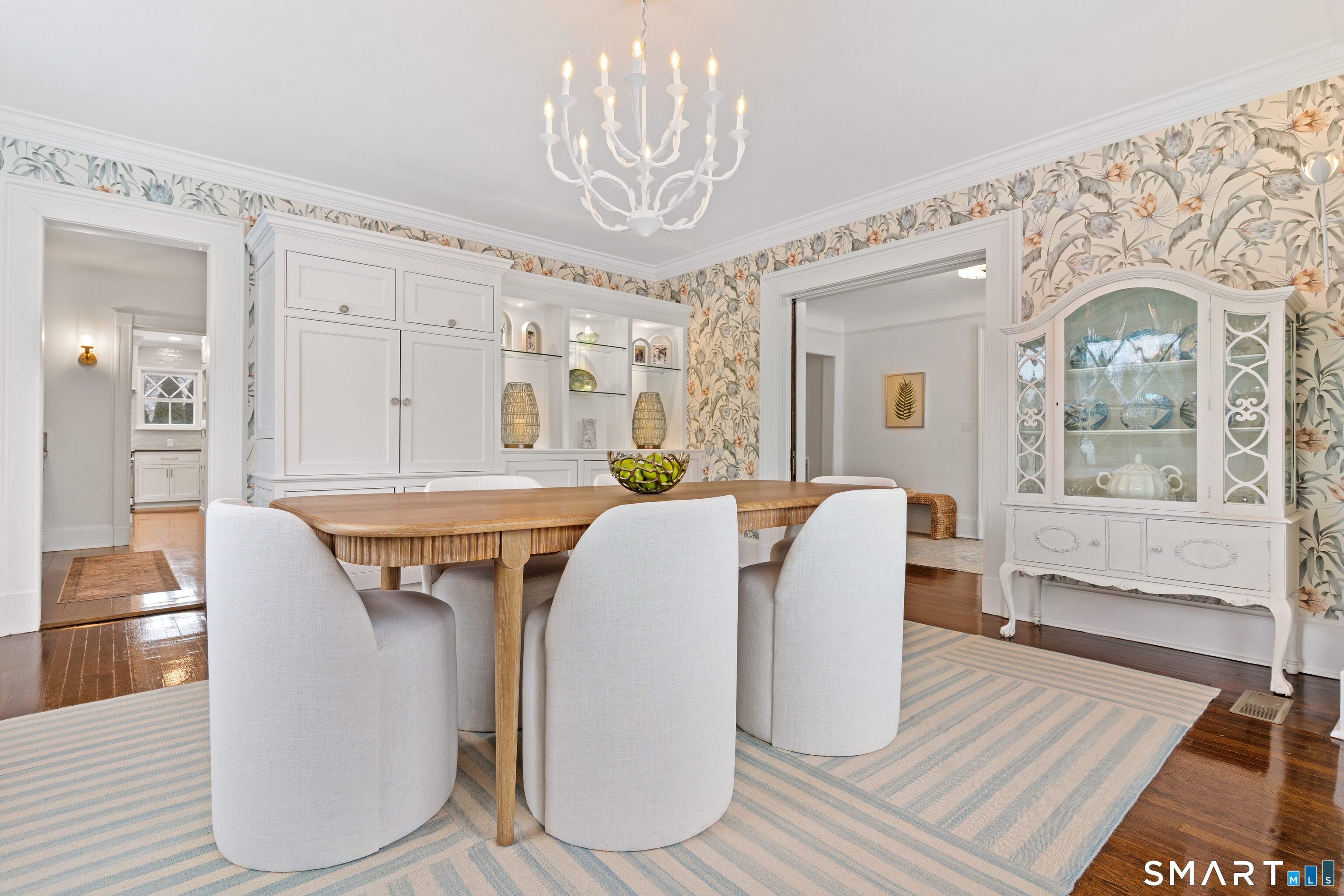 40 Rogers Road Stamford, CT 06902 - Photo 18 of 40 a dining room with wooden floor a chandelier a wooden table and chairs