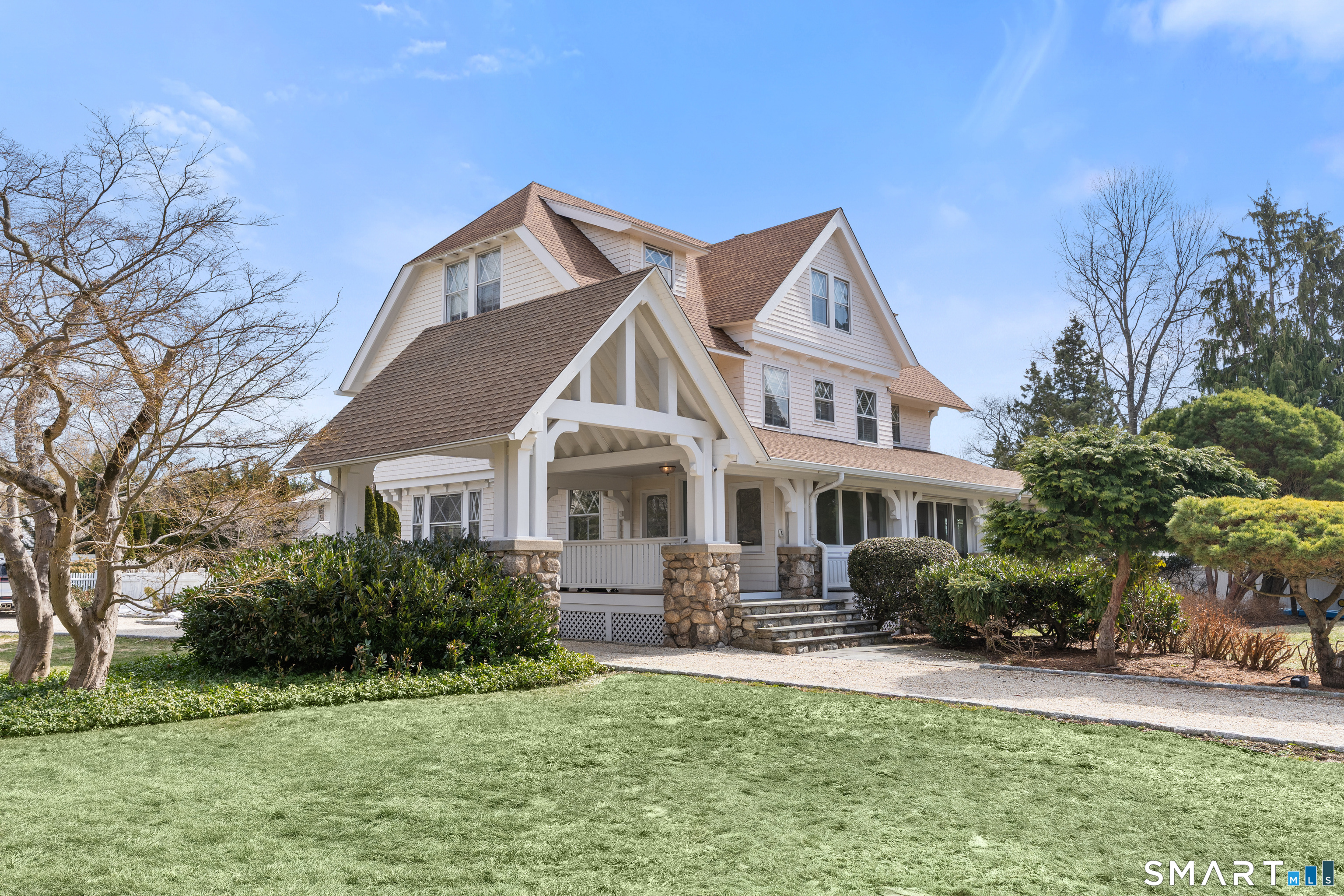 40 Rogers Road Stamford, CT 06902 - Photo 4 of 40 a front view of a house with a garden and lake view