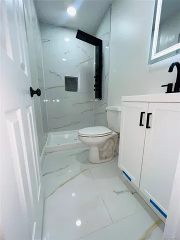a bathroom with a toilet sink and a shower