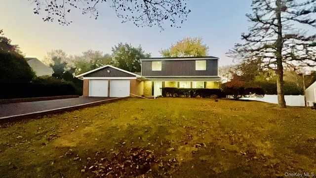 a front view of a house with a yard covered with snow