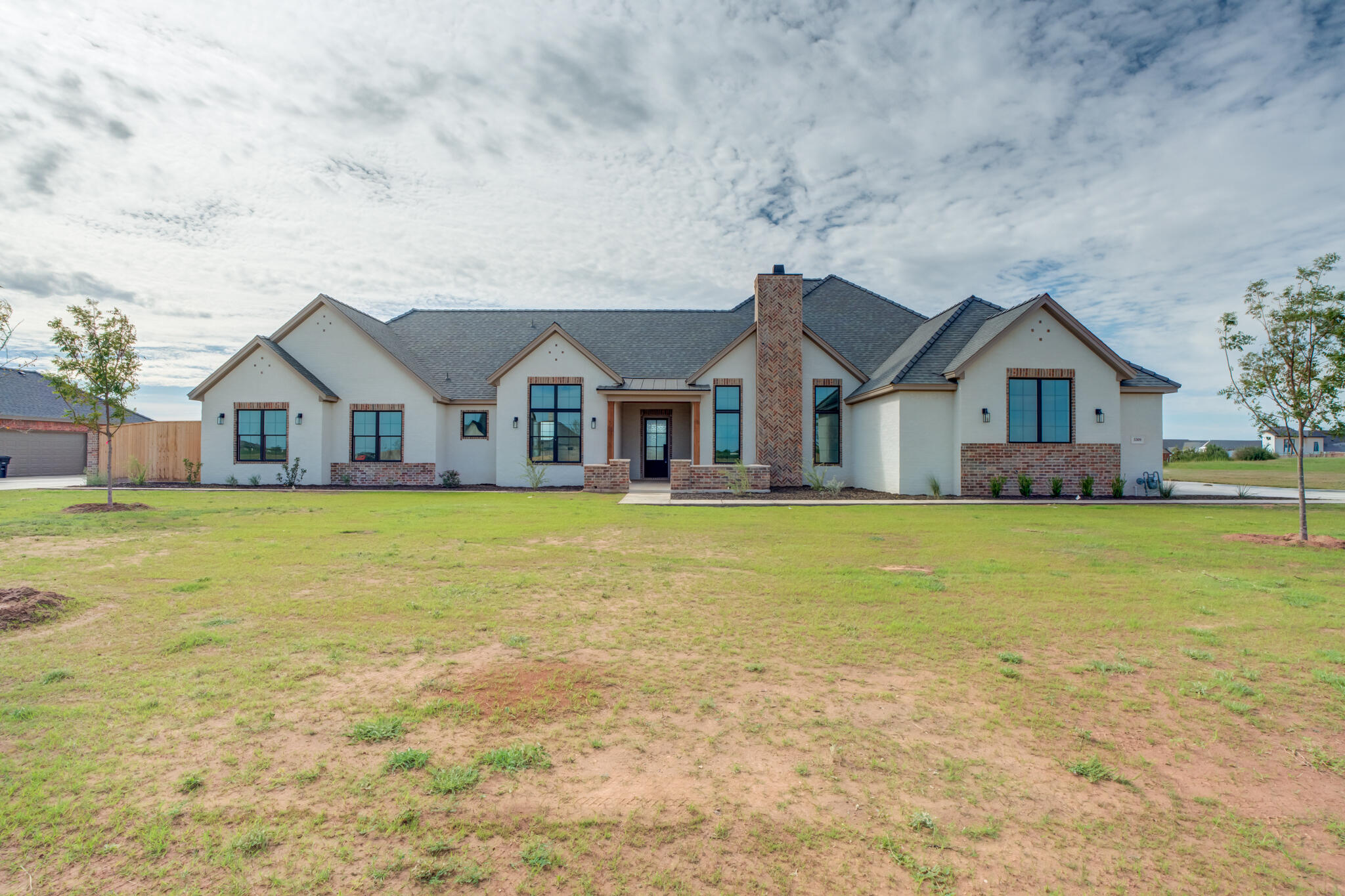 a front view of house with yard and swimming pool