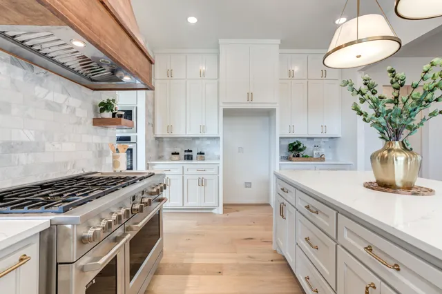 a kitchen with white cabinets and a sink