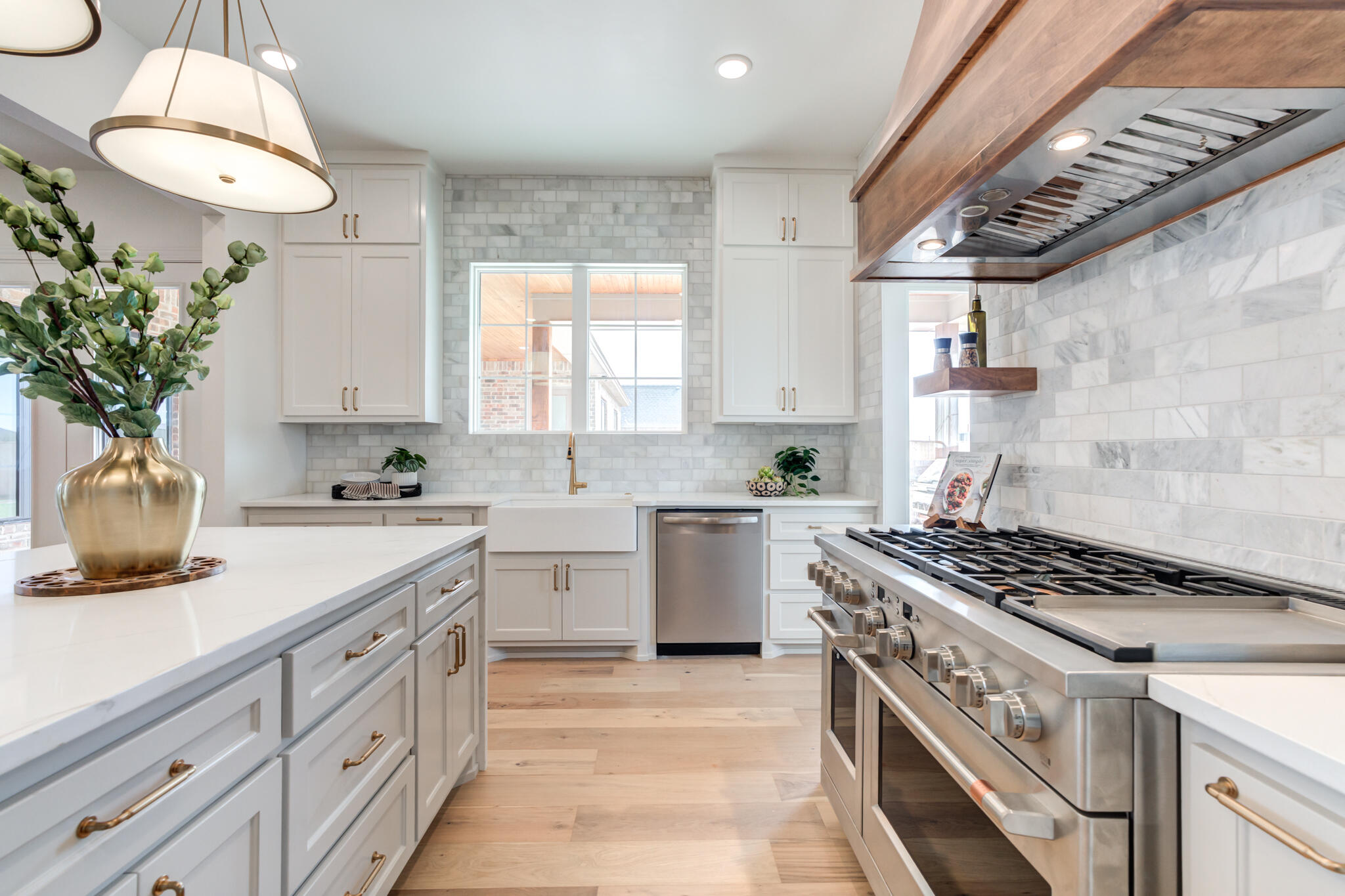 5309 County Road 7670 Lubbock, TX 79424 - Photo 16 of 57 a kitchen with stainless steel appliances a sink stove and cabinets