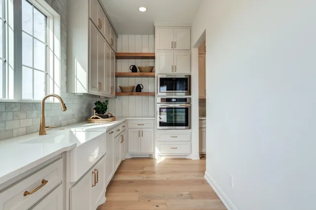 a view of a kitchen with a dishwasher and a cabinet