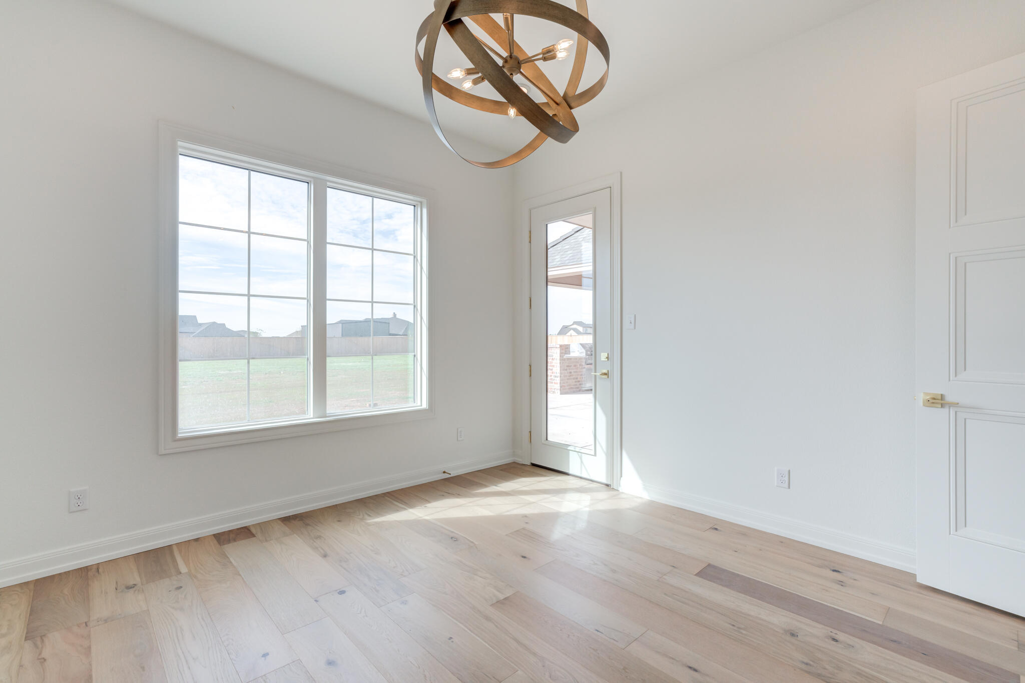 5309 County Road 7670 Lubbock, TX 79424 - Photo 28 of 57 an empty room with wooden floor and windows