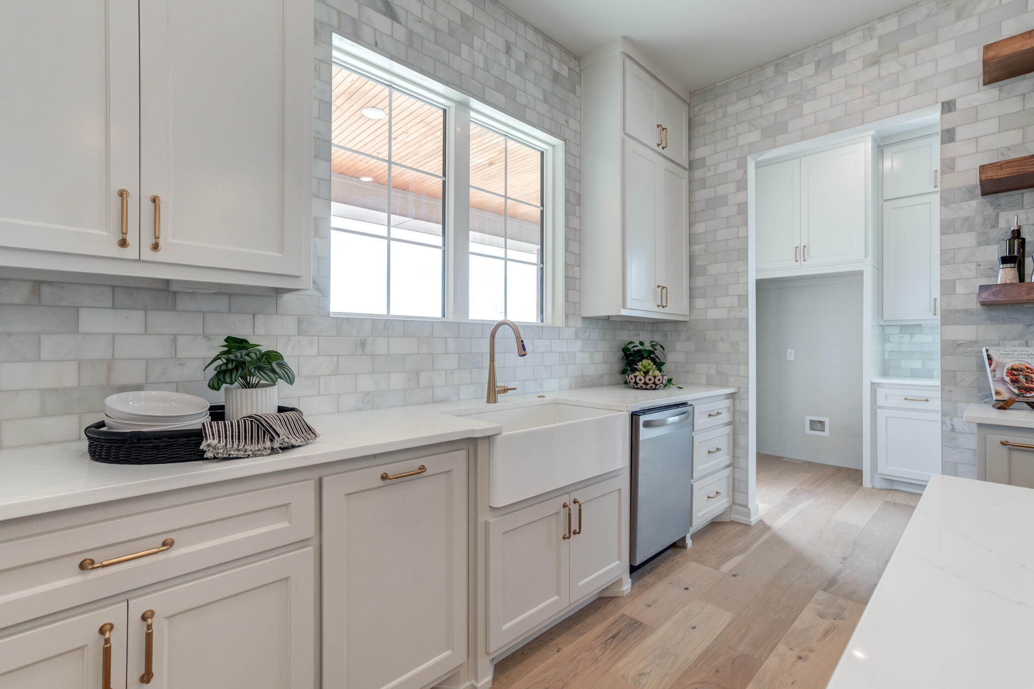 5309 County Road 7670 Lubbock, TX 79424 - Photo 37 of 57 a kitchen with white cabinets and white appliances
