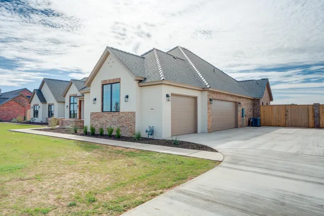 a front view of house with yard and garage