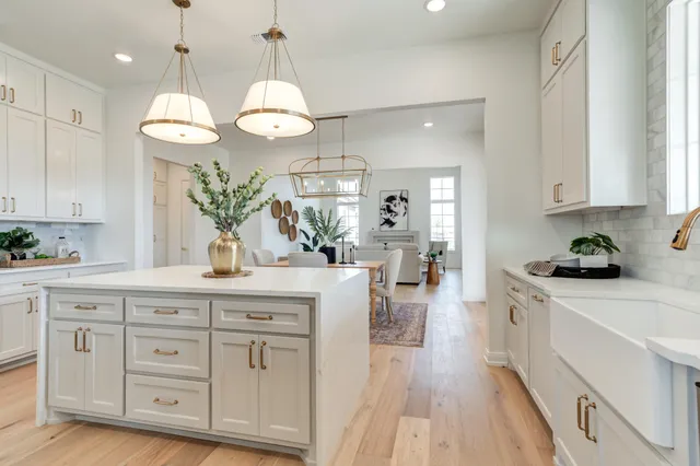 a bathroom with a sink a potted plant and a mirror