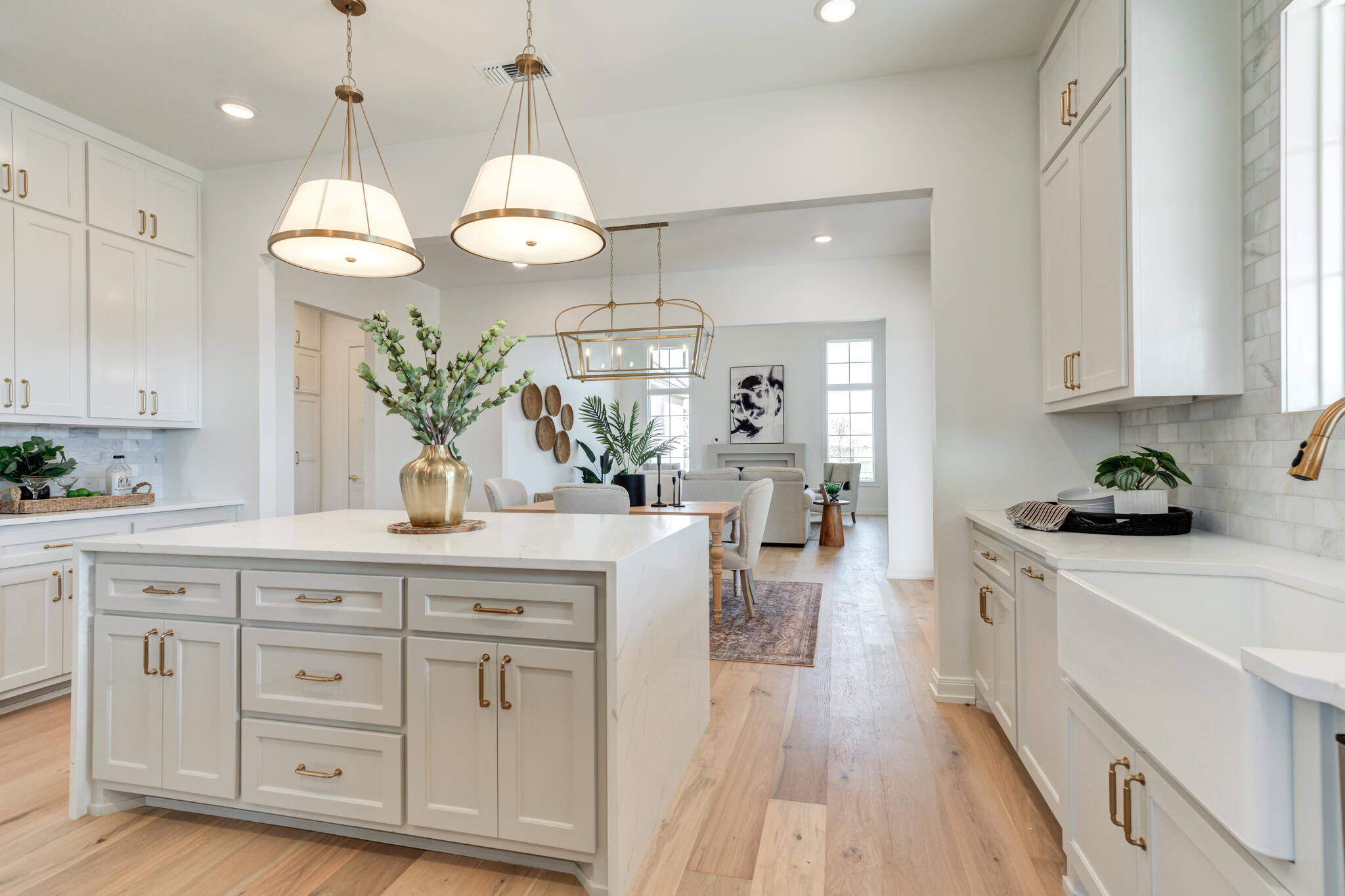 5309 County Road 7670 Lubbock, TX 79424 - Photo 42 of 57 a large kitchen with white cabinets and chandelier