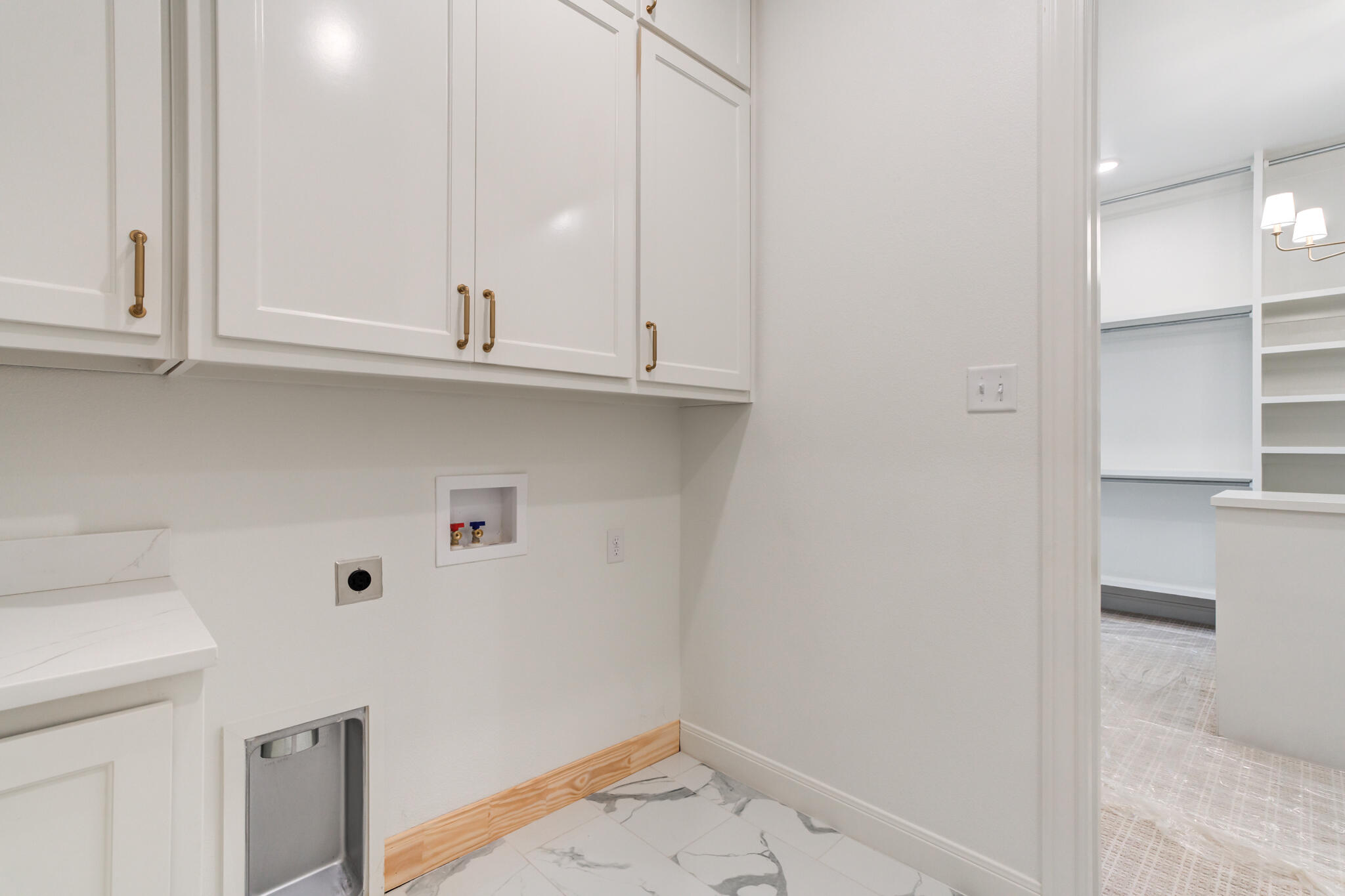 5309 County Road 7670 Lubbock, TX 79424 - Photo 44 of 57 a view of storage and utility room with wooden floor