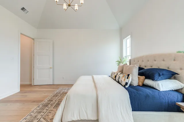 an empty room with a window and a ceiling fan