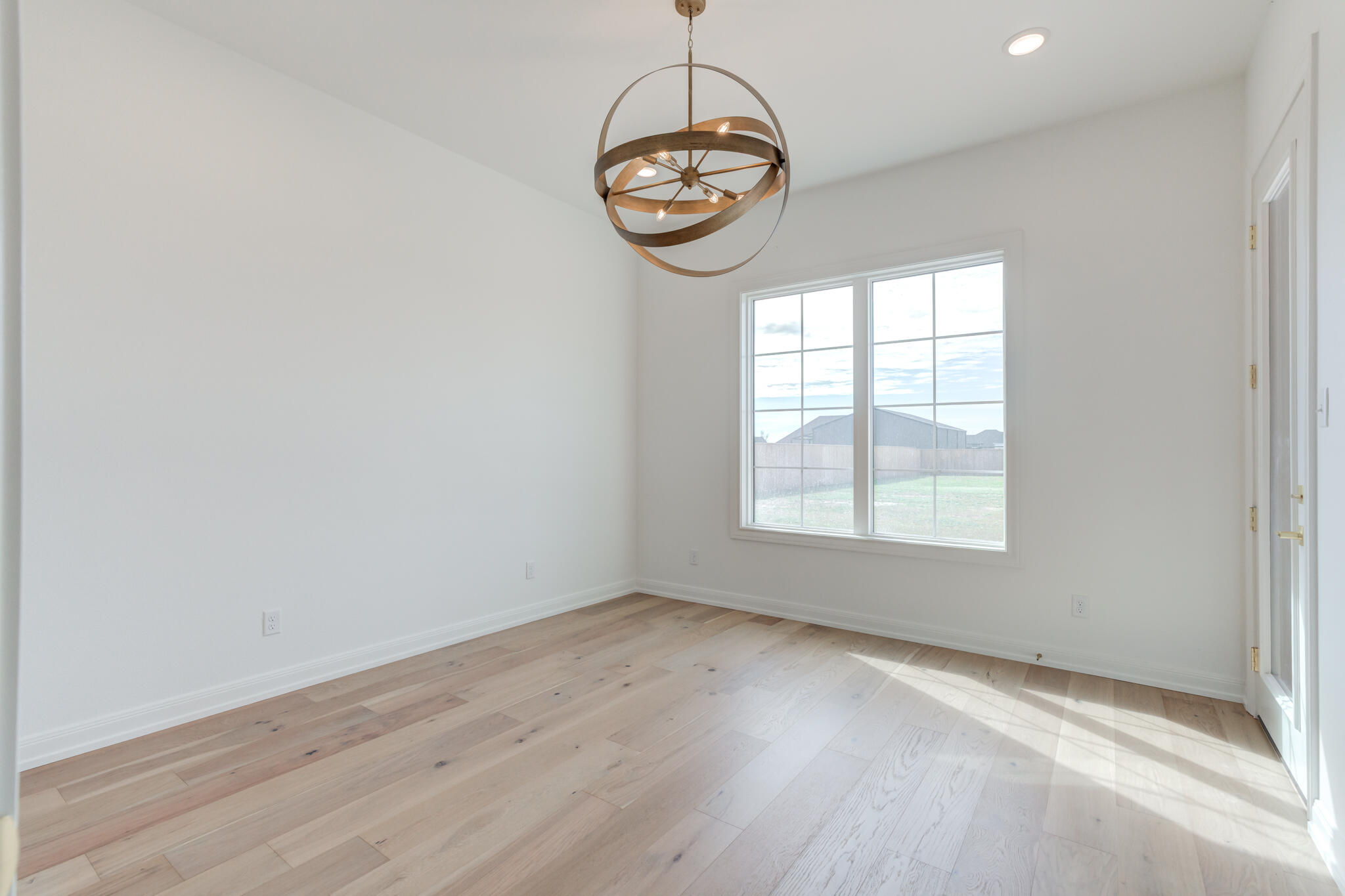 5309 County Road 7670 Lubbock, TX 79424 - Photo 50 of 57 an empty room with wooden floor and windows
