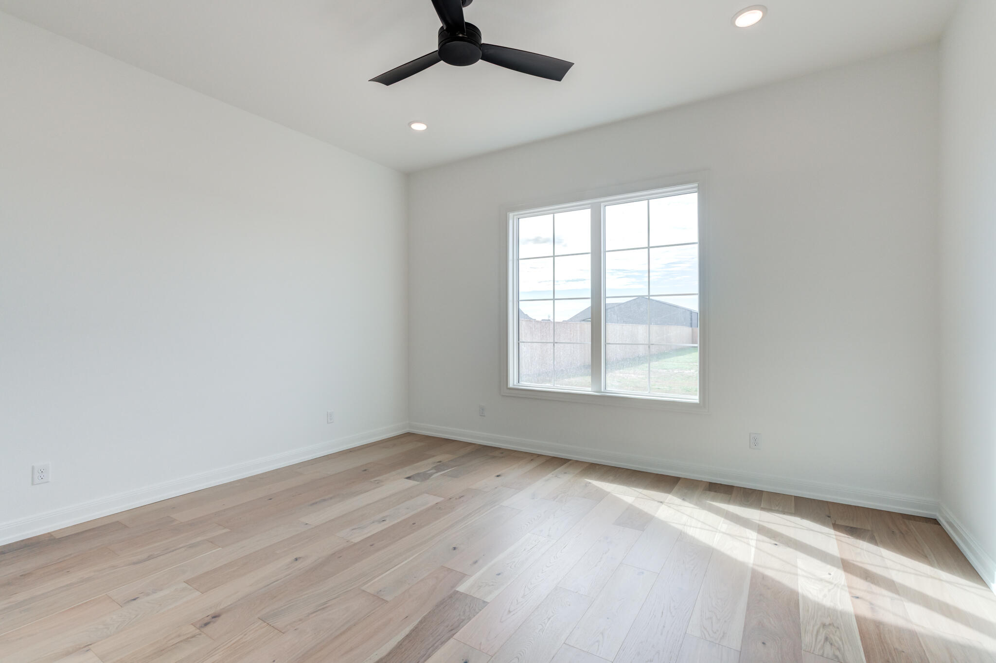 5309 County Road 7670 Lubbock, TX 79424 - Photo 51 of 57 an empty room with a window and a ceiling fan