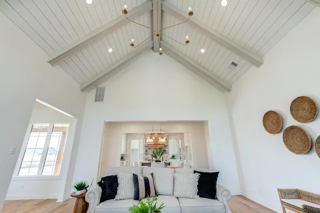 a view of a dining room with furniture a chandelier and wooden floor