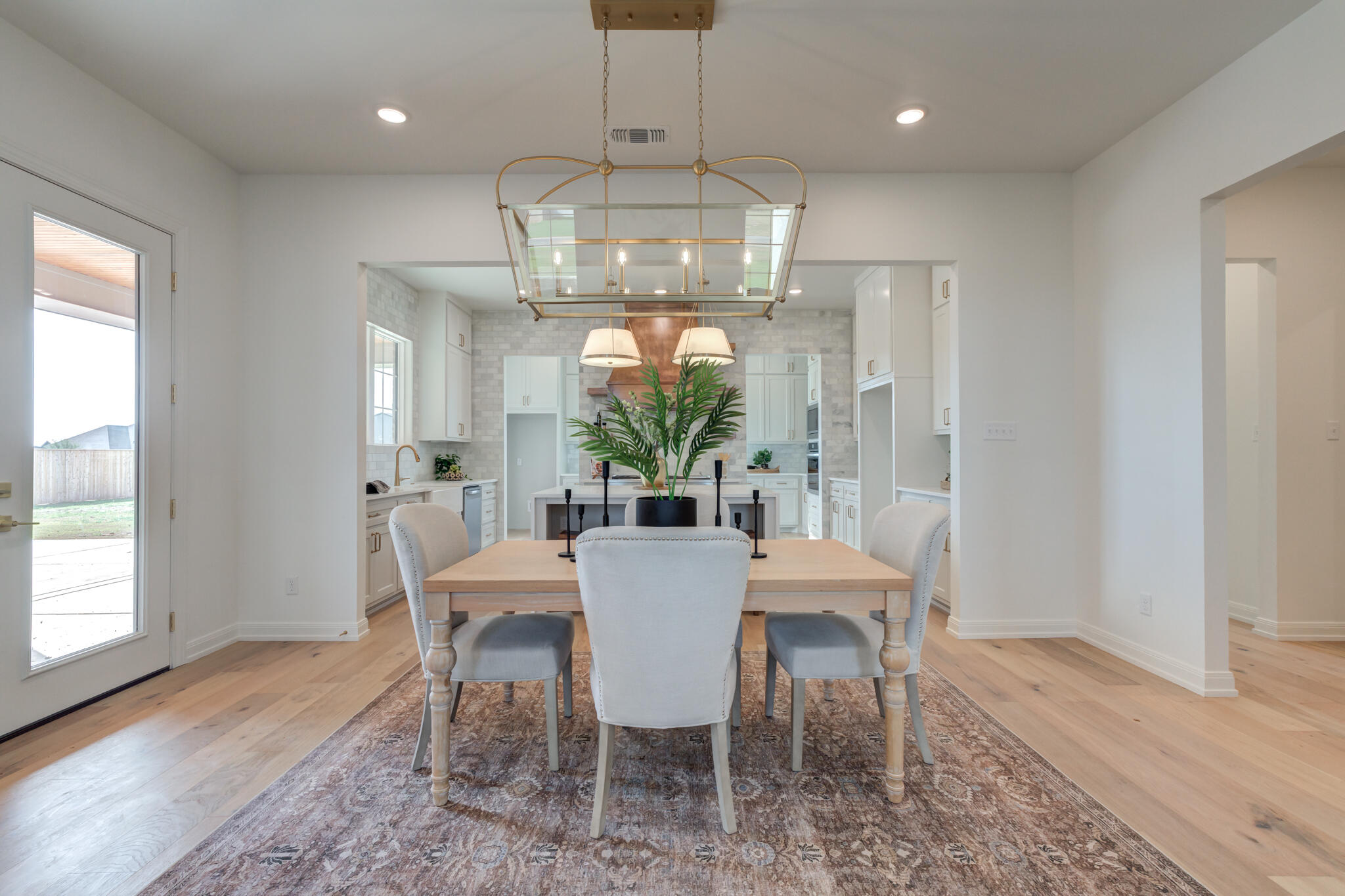 5309 County Road 7670 Lubbock, TX 79424 - Photo 10 of 57 a view of a dining room with furniture a chandelier and wooden floor
