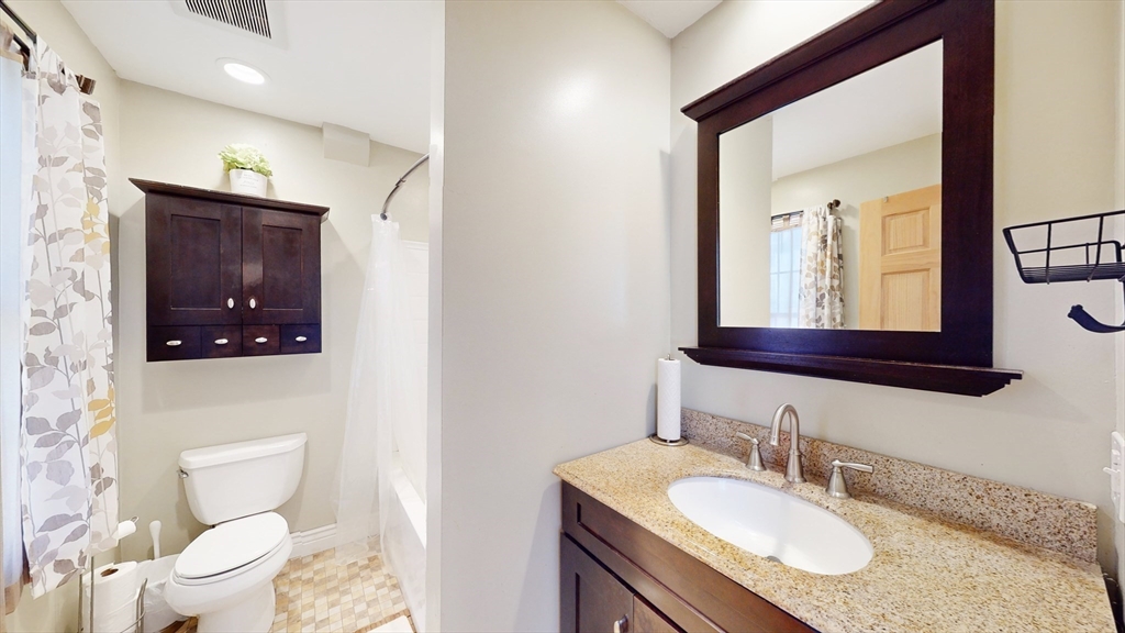 68 Meadow Cart Way Millis, MA 02054 - Photo 14 of 28 a bathroom with a granite countertop toilet sink and mirror