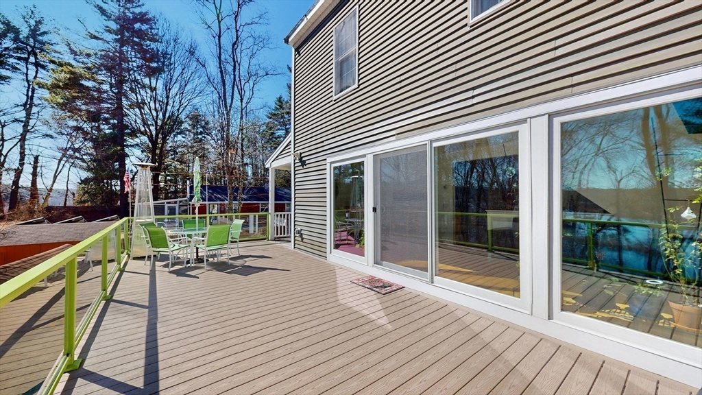 68 Meadow Cart Way Millis, MA 02054 - Photo 19 of 28 a patio with table and chairs and wooden floor