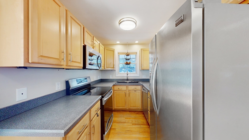 68 Meadow Cart Way Millis, MA 02054 - Photo 7 of 28 a kitchen with a sink and a refrigerator