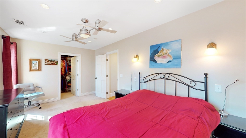 68 Meadow Cart Way Millis, MA 02054 - Photo 10 of 28 a bedroom with a bed and a chandelier