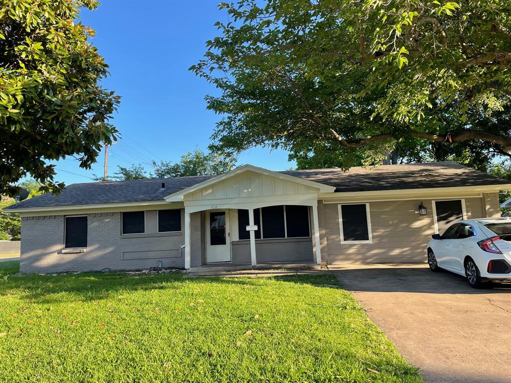 102 Roma Drive Garland, TX 75041 - Photo 1 of 9 Single-story residence featuring a covered entry, light-colored siding, and a partial brick exterior