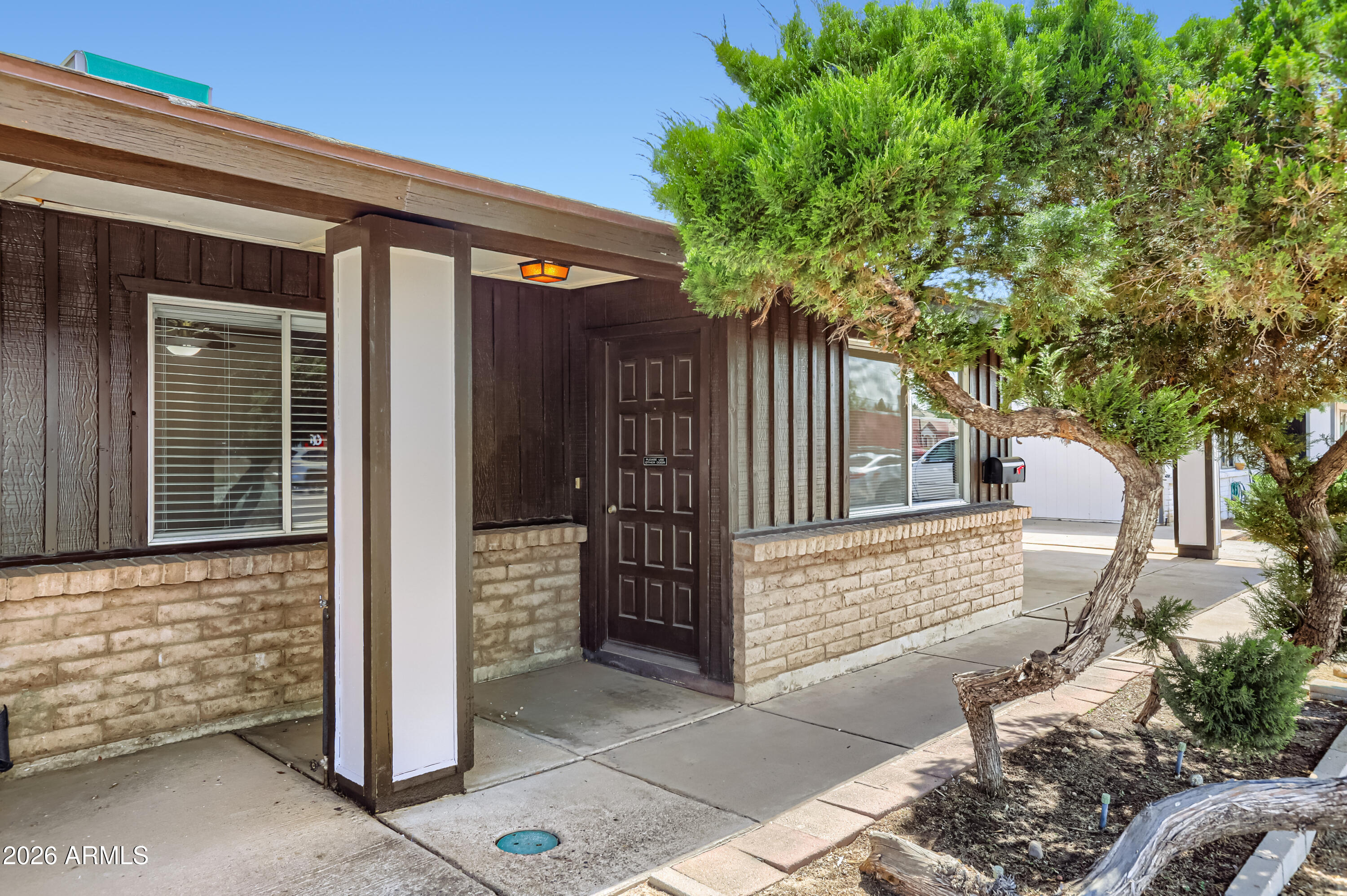 3823 West Greenway Road Phoenix, AZ 85053 - Photo 5 of 28 a front view of a house with a tree