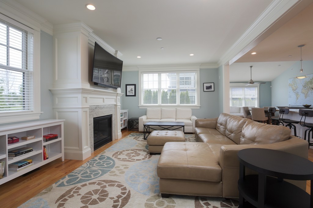 23 Lillian Way, Unit 28 Wayland, MA 01778 - Photo 3 of 16 a living room with furniture a flat screen tv and a fireplace