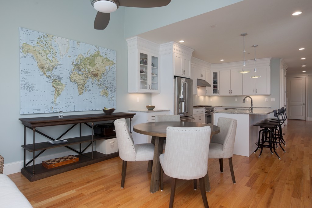 23 Lillian Way, Unit 28 Wayland, MA 01778 - Photo 4 of 16 a dining room with furniture a rug and wooden floor