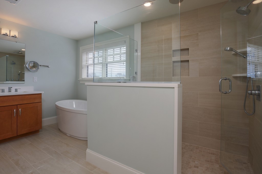 23 Lillian Way, Unit 28 Wayland, MA 01778 - Photo 8 of 16 a bathroom with a granite countertop sink a toilet and shower