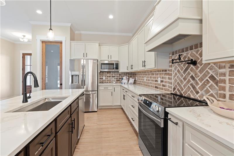 160 Old Sandhill Road Carrollton, GA 30116 - Photo 13 of 39 a kitchen with stainless steel appliances granite countertop a sink stove oven a refrigerator with white cabinets and island